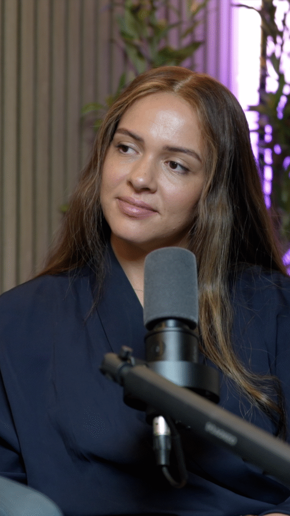 Close-up portrait of a podcast guest speaking into a microphone