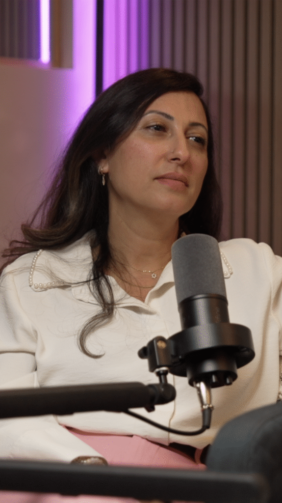 Close-up portrait of a second podcast guest speaking into a microphone