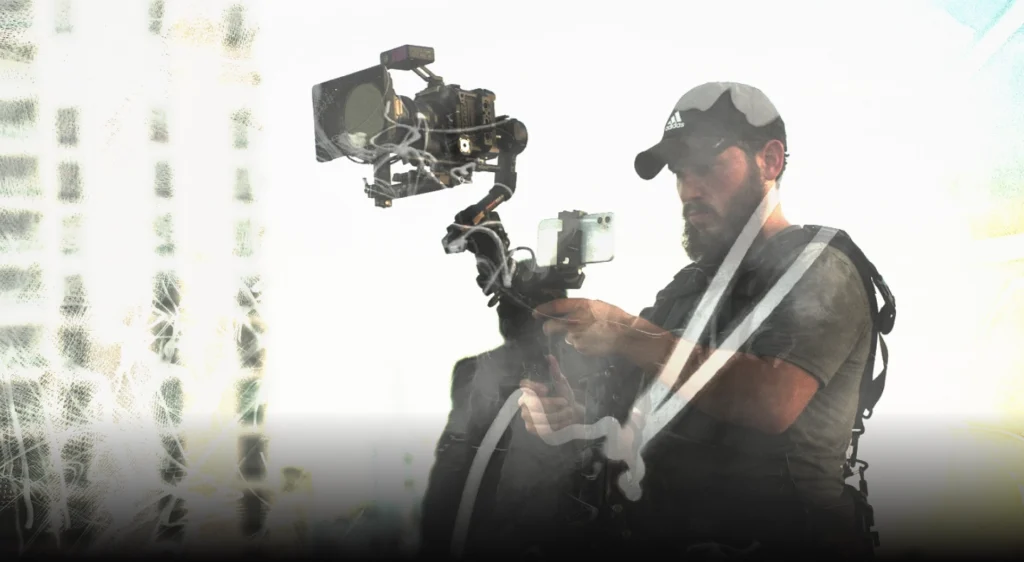 Dov Gurewicz filming with a gimbal at sunset