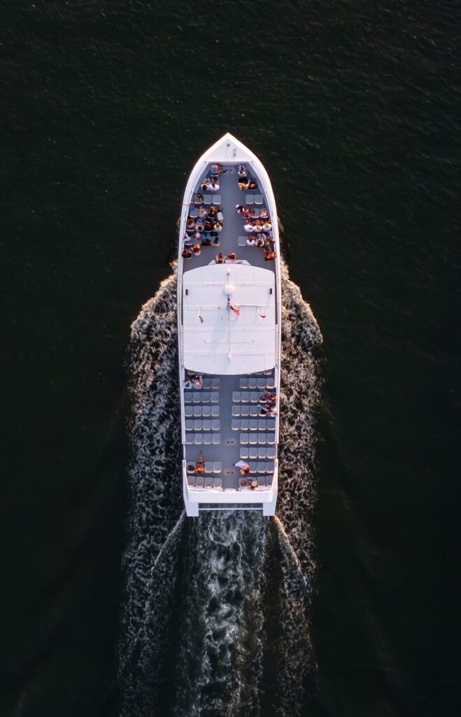 Overhead drone photograph of the Sea Rocket boat underway off Fort Lauderdale with passengers seated along both rails