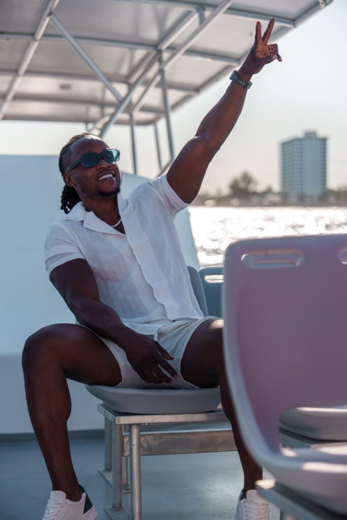 Guest laughing on the deck of the Sea Rocket sunset cruise with the Fort Lauderdale skyline behind