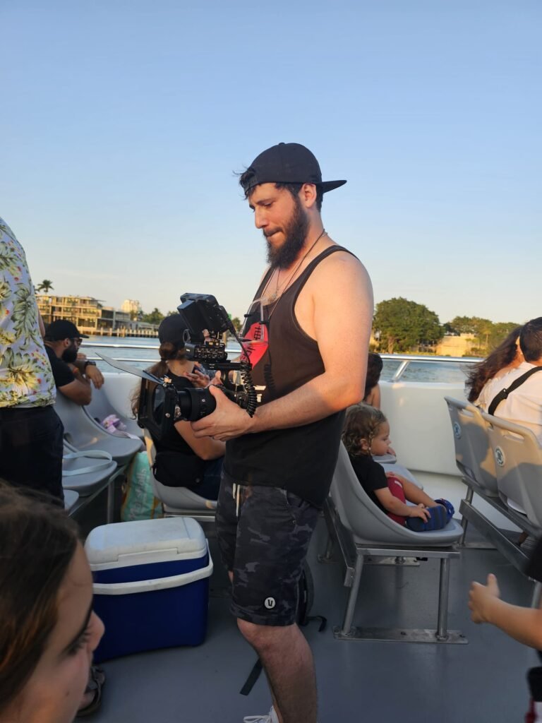 Camera operator with a gimbal-mounted cinema camera filming on board during the Sea Rocket shoot
