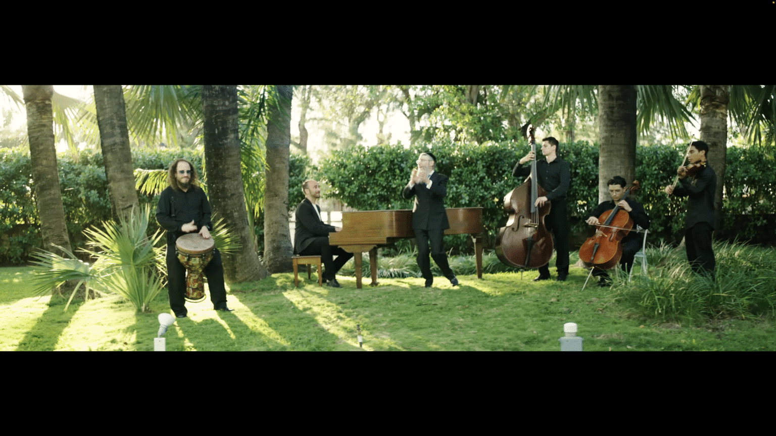 band performing outside piano bongo cello