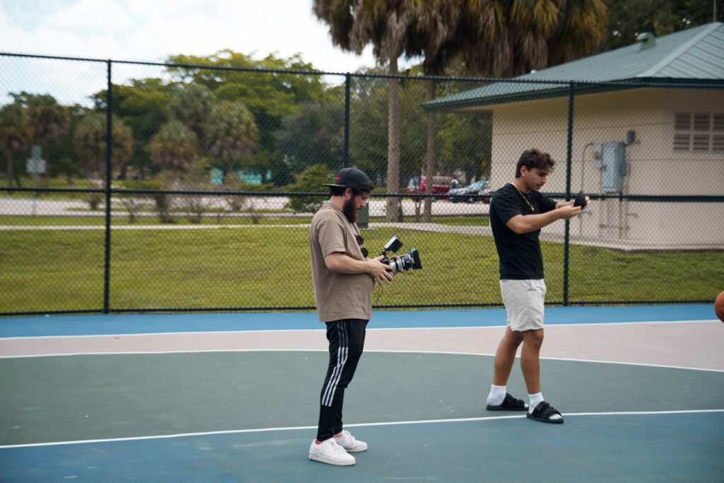 Two videographers reviewing camera footage during a shoot