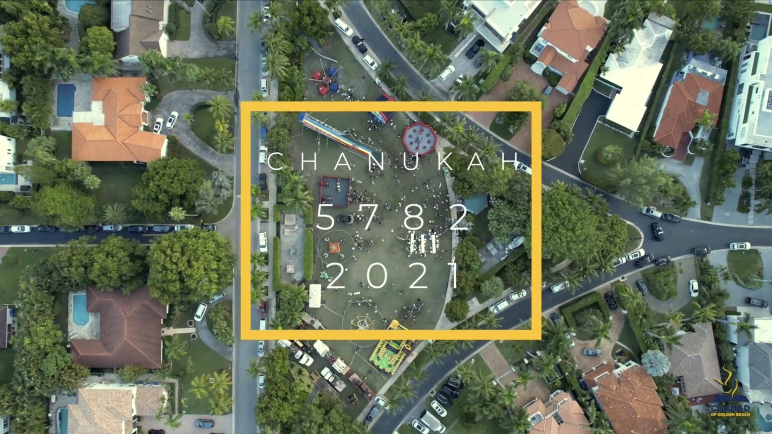 Overhead aerial of a park and surrounding houses with text reading Chanukah 5782 2021