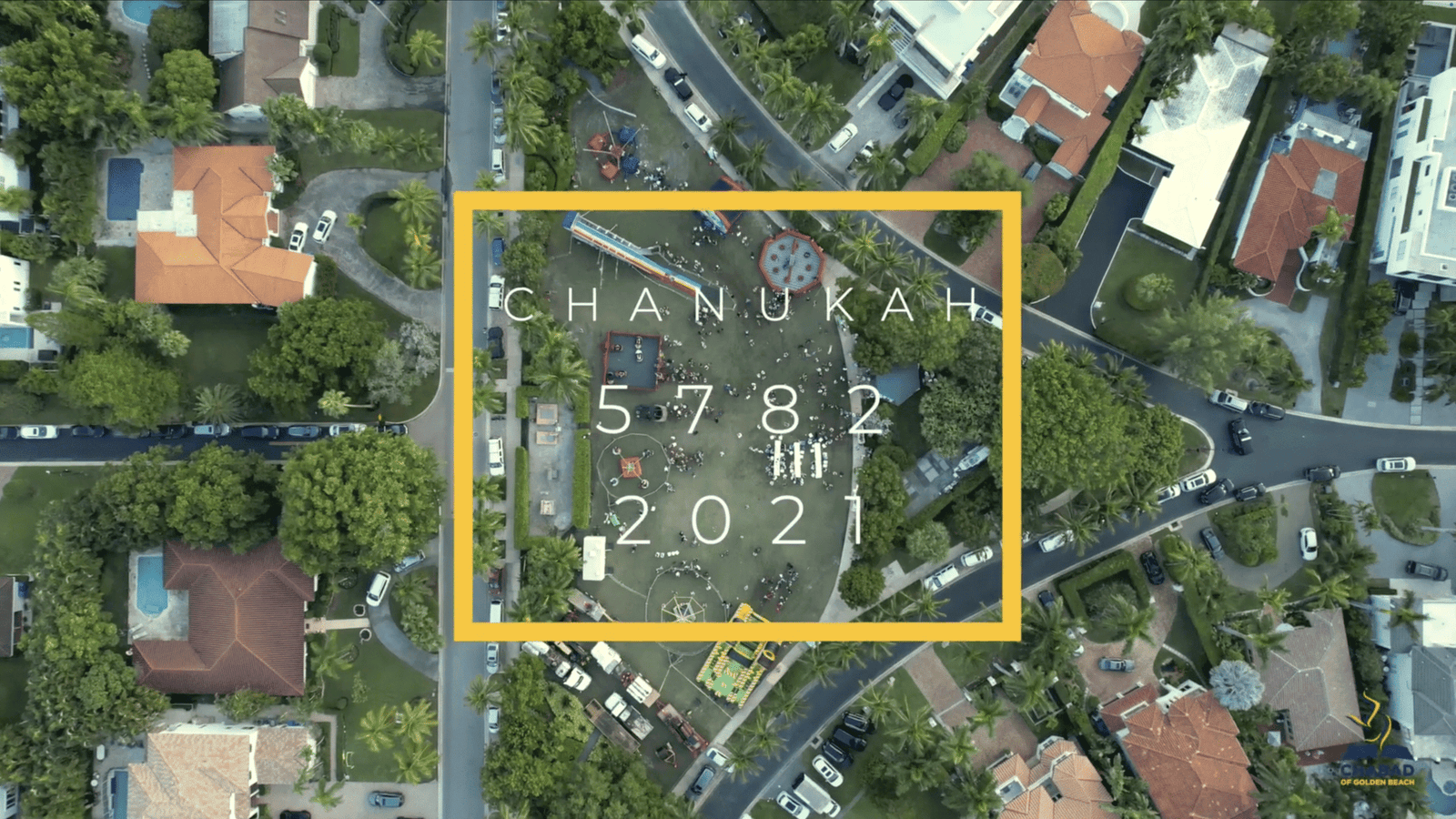 Overhead aerial of a park and surrounding houses with text reading Chanukah 5782 2021