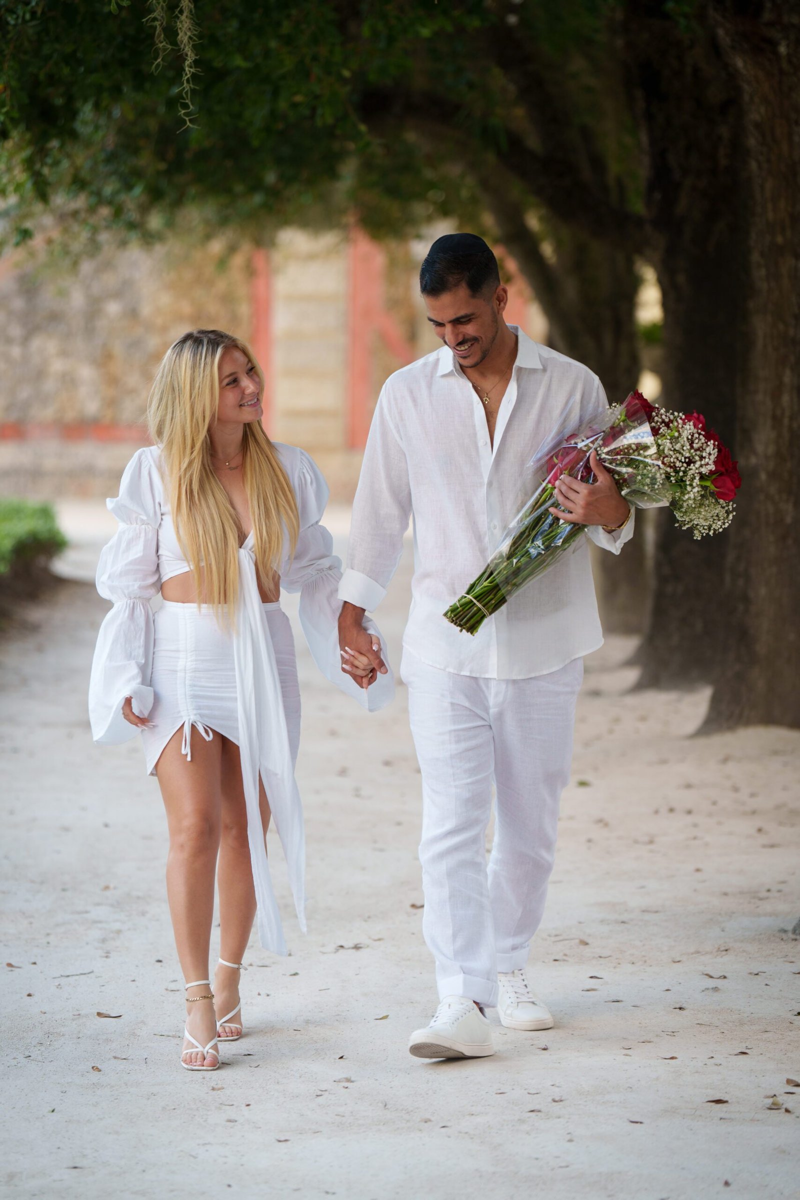 Bex and Dor embracing in the gardens at Vizcaya just after their proposal