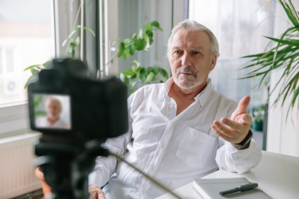 Senior man being interviewed on camera for a documentary-style legacy film