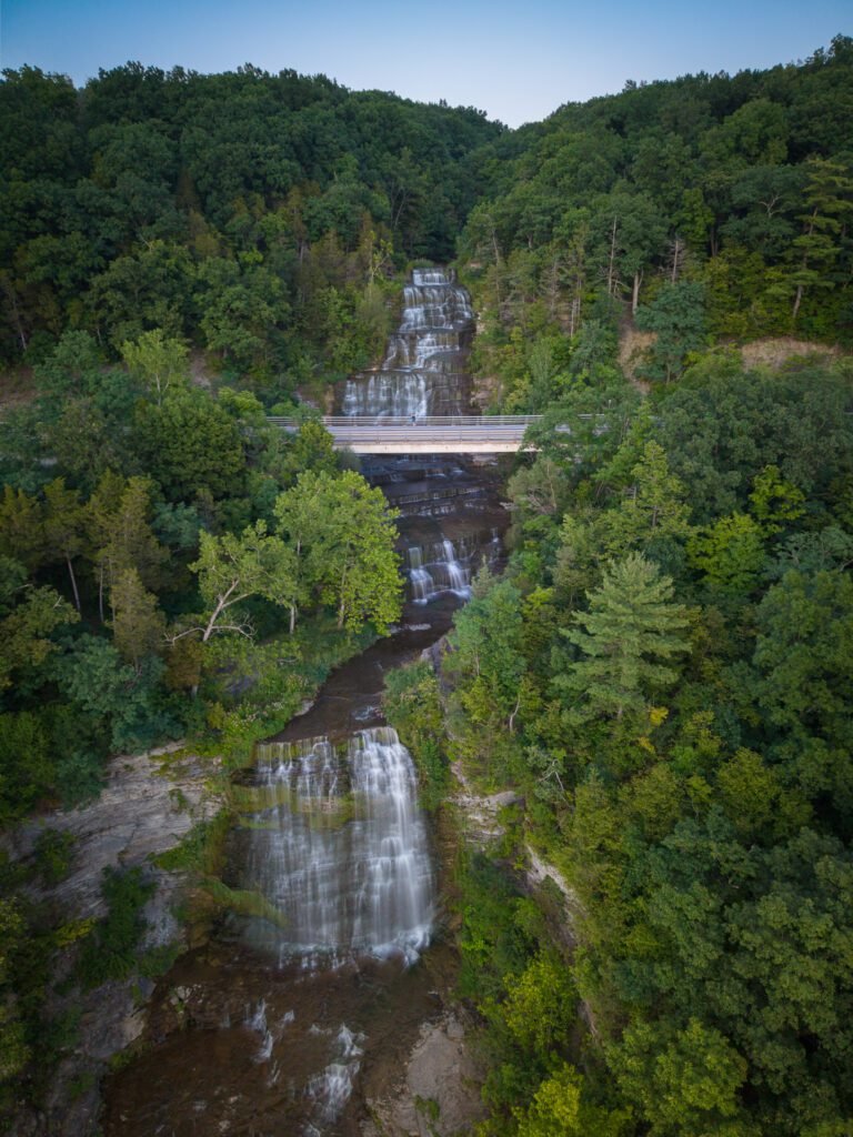 Aerial view of Hector Falls with the highway bridge crossing partway down the cascade