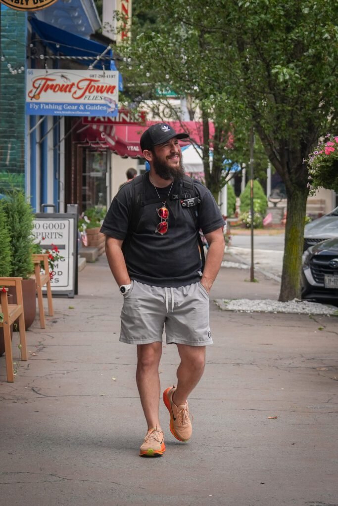 Dov Gurewicz walking down the main street in Montour Falls, New York, past a fly-fishing shop