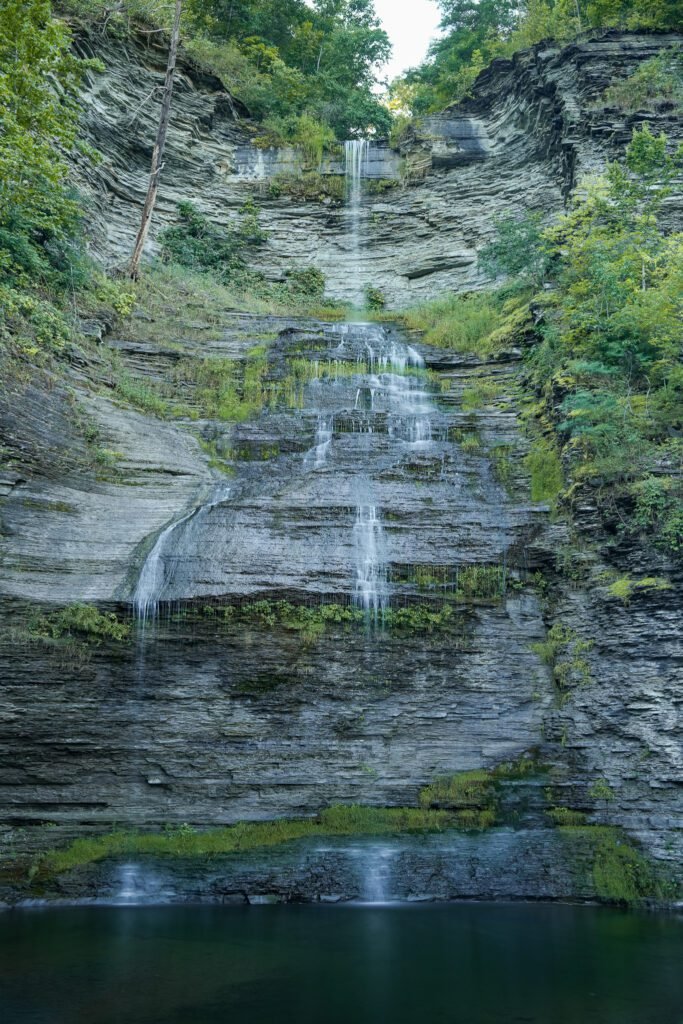 Aunt Sarah's Falls in Montour Falls, New York, spilling in tiers down a broad shale face into a green plunge pool