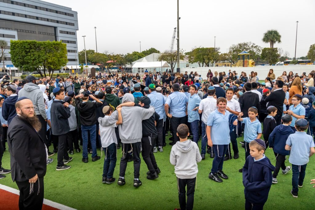 More than a thousand Lubavitch Educational Center students gathered on the turf field for the all-school scene of the Gift to the Rebbe music video