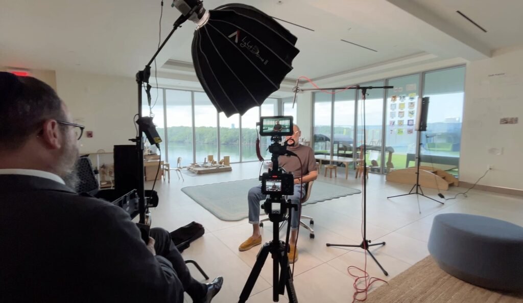 Behind the scenes of a waterfront interview, softbox and boom mic positioned around the subject
