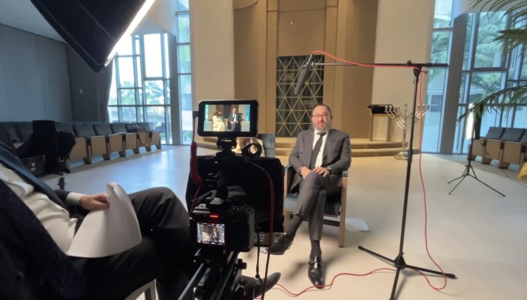 Interview filmed in front of the sanctuary ark, boom mic and camera monitor in frame