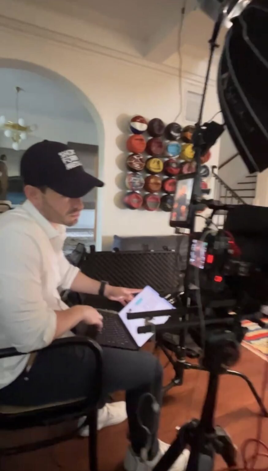 Behind the camera on a corporate interview, the second operator working from a laptop beside the rig