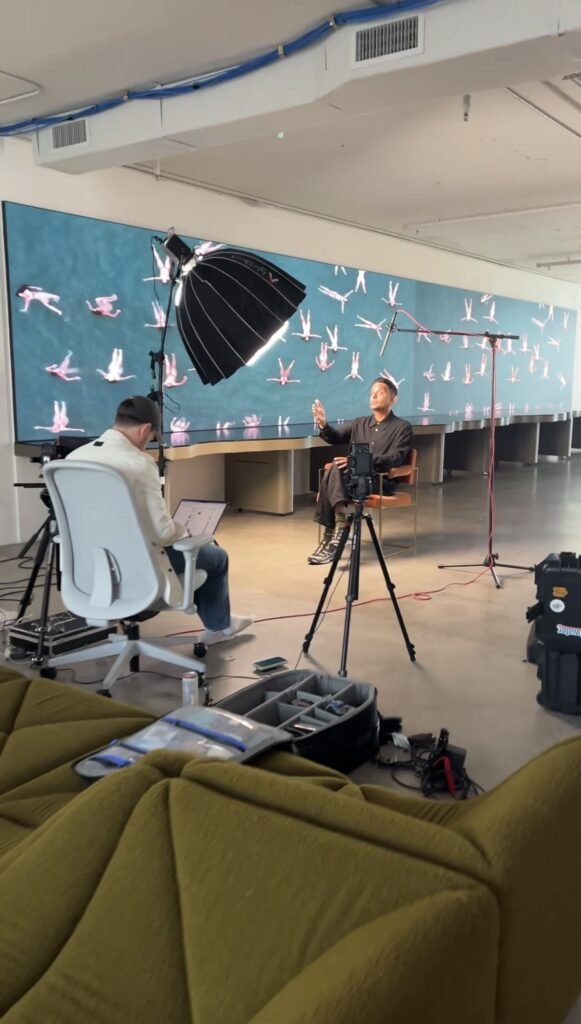 Interview set against a painted mural wall, camera and boom in position on a corporate shoot