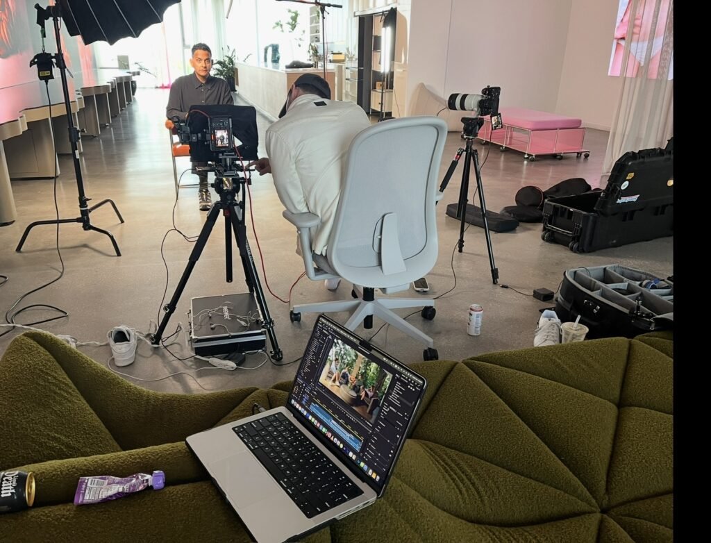 Two-camera office interview set up beside a laptop, chairs and lighting stands in position