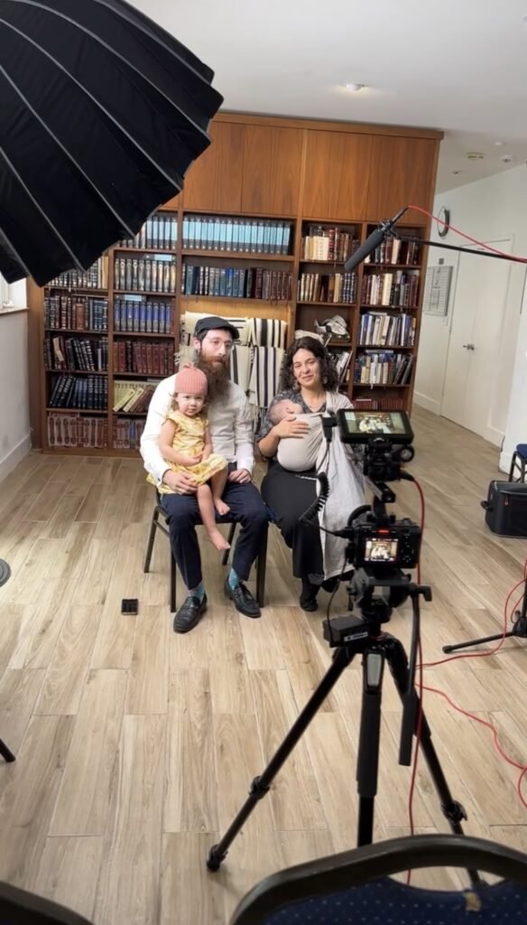 A family seated together for a filmed portrait during a legacy session