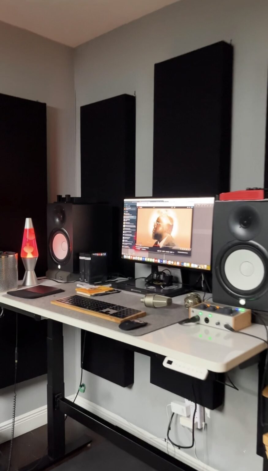 Editing desk with studio monitors, a lava lamp and an edit in progress