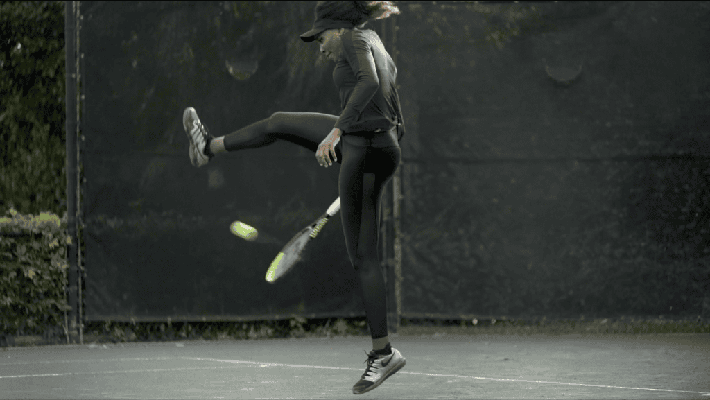 Venus Williams airborne mid-swing on the tennis court, racket and ball caught in the same frame
