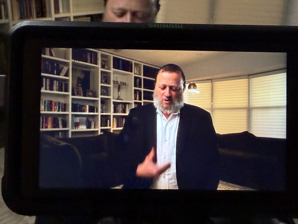 A man telling his story to camera during a legacy film session