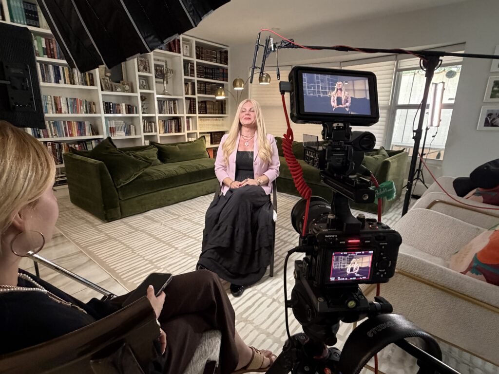 Interviewer and camera monitor during a legacy film conversation