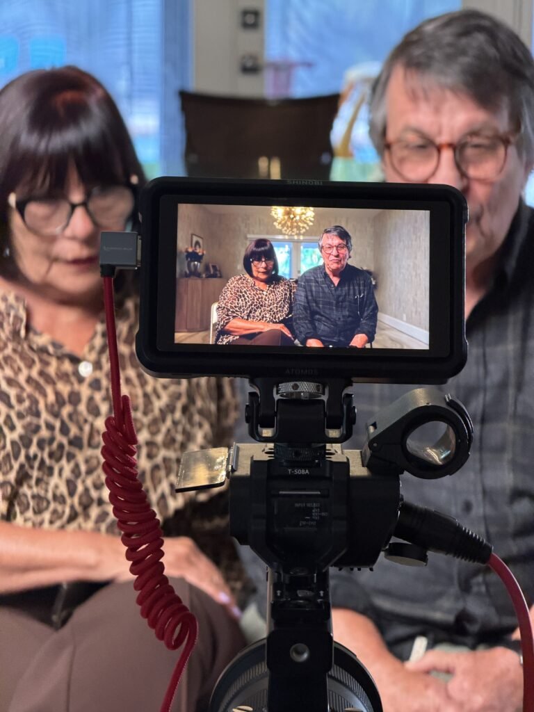 Camera monitor showing a couple mid-interview during a legacy film session